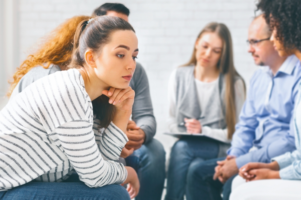 A woman with anxiety disorder in a group therapy session.