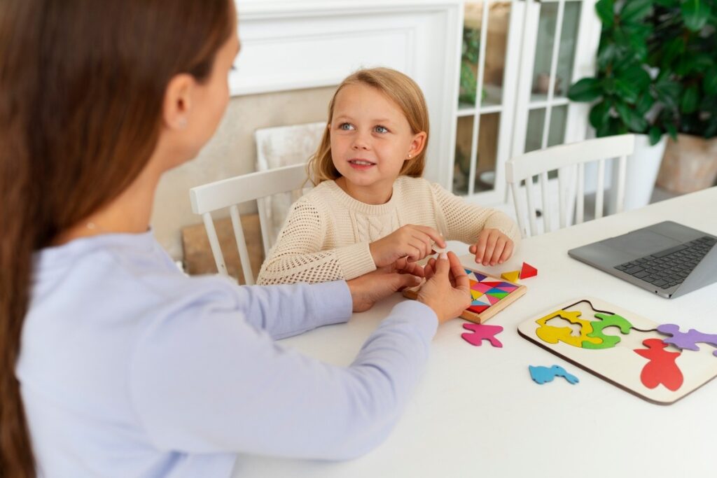 A little girl arranging her puzzle in a specific way.
