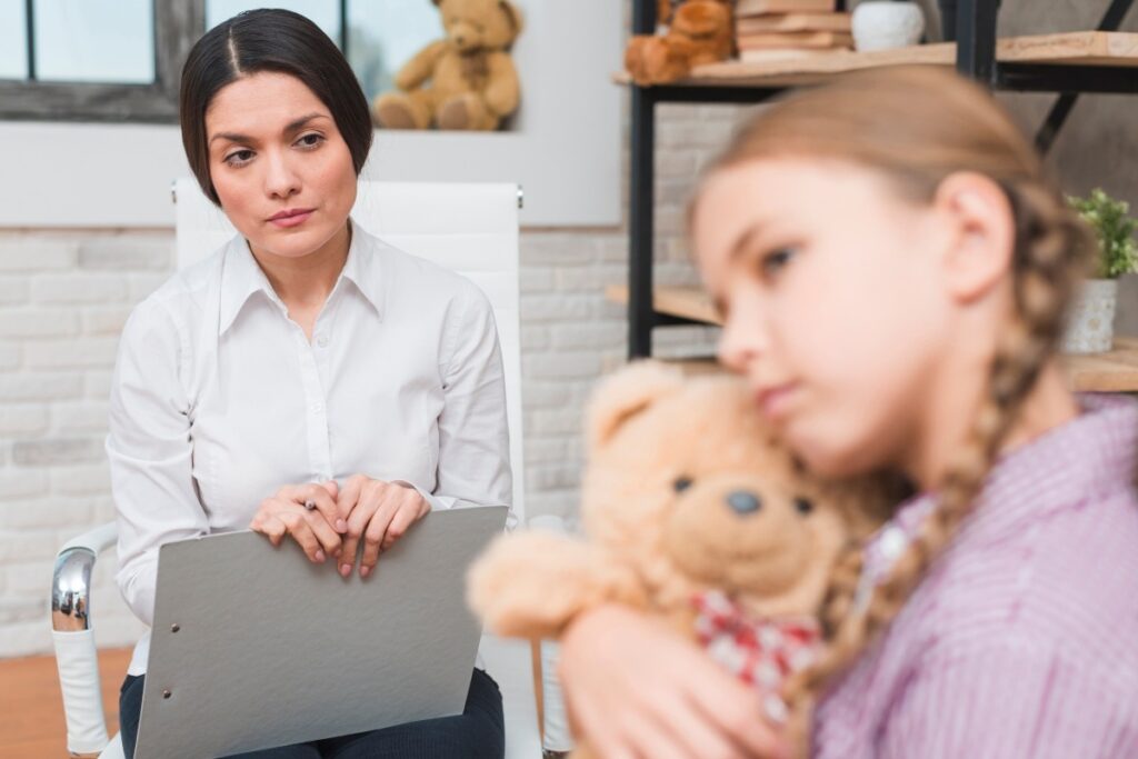 A child psychologist working with a little girl.